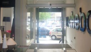 Entrance of a commercial building with an open automatic glass sliding door.