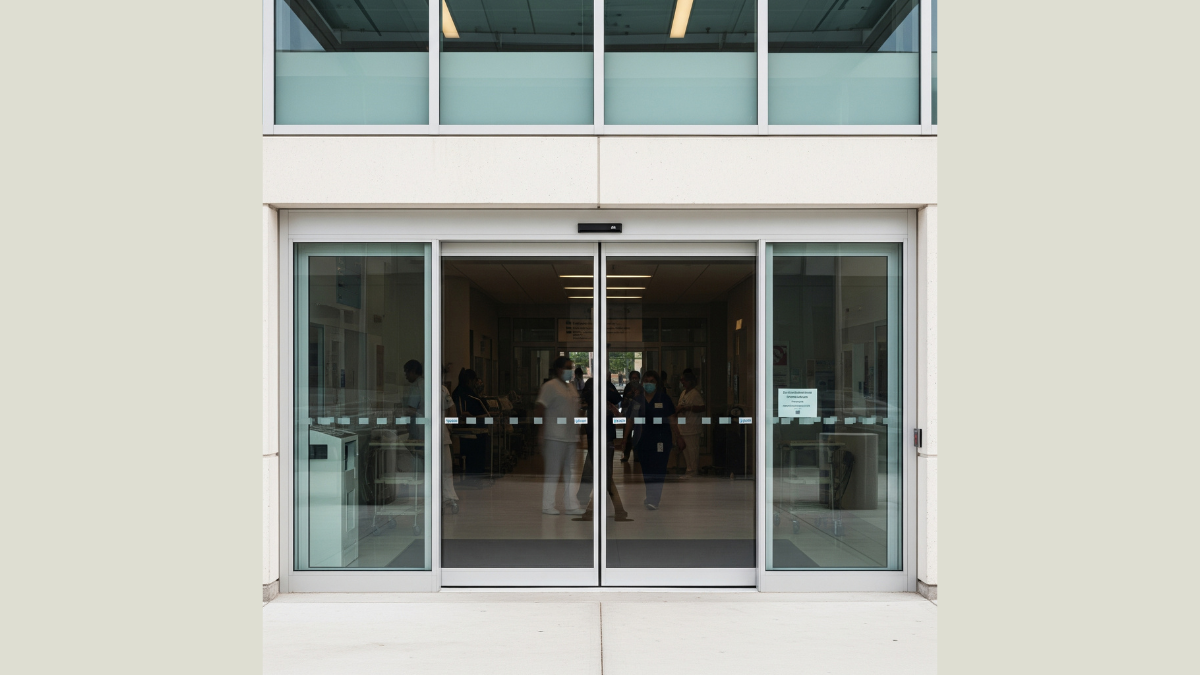 healthcare facility entrance with automatic swing doors showing clean