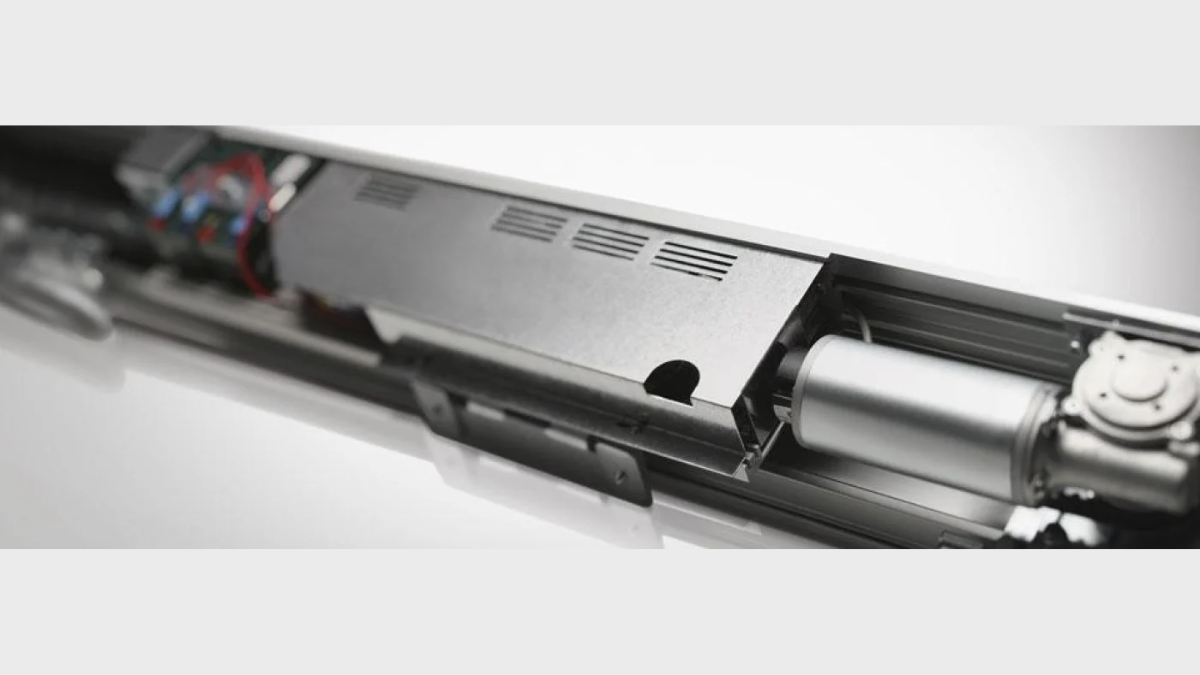 Close-up view of the fixed hardware elements and complex stainless steel track and roller mechanism of a modern sliding door system.